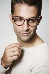 Handsome guy looking away in glasses, studio