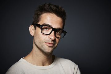 Handsome fellow in glasses in studio portrait