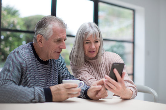 Senior couple using a smartphone together