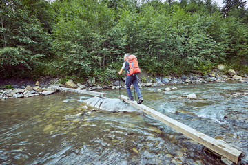 Obraz premium Hiking in the mountains in the summer with a backpack.
