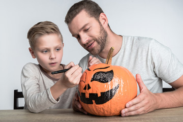 father and son with halloween pumpkin