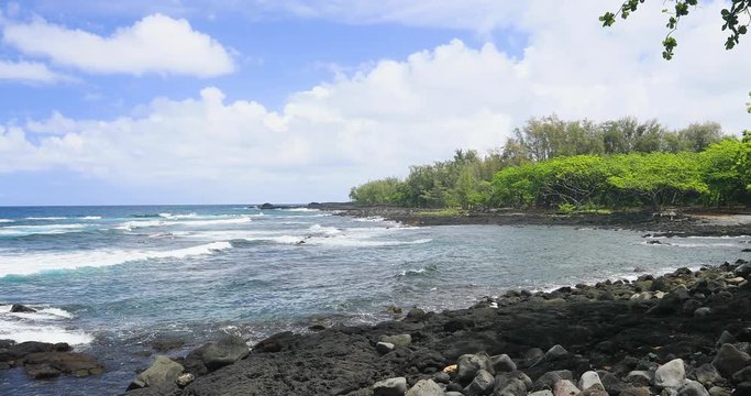 Hilo Hawaii rocky tropical beach shore. Destination for swimming, scuba and snorkel, underwater fish and coral. Big Island, largest, most volcanic active. Economy is tourism based. Water and tropical.