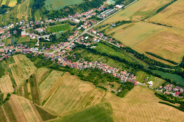 Fototapeta na wymiar Aerial view of unidentified village in summer countryside during sunset.