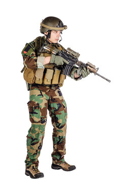 Portrait soldier or private military contractor holding sniper rifle.