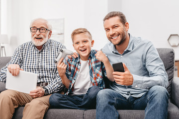 Family cheering for boy playing videogames