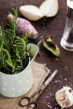 A bunch of fresh rosemary in  a metal pot