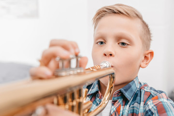 boy practicing trumpet