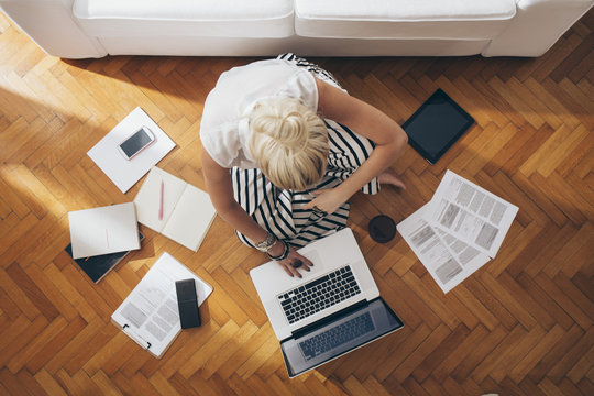Businesswoman Sitting on the Floor and Working