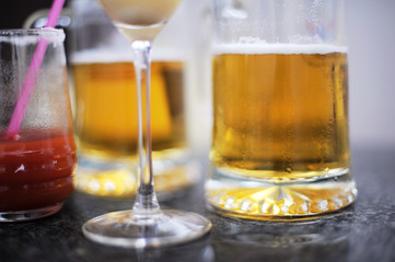 Beer and sparkling wine in glasses on a black table