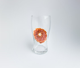 Dried grapefruit in a glass. Memory of past summer. Dried fruit preserved in glass. Metaphor of memory.
