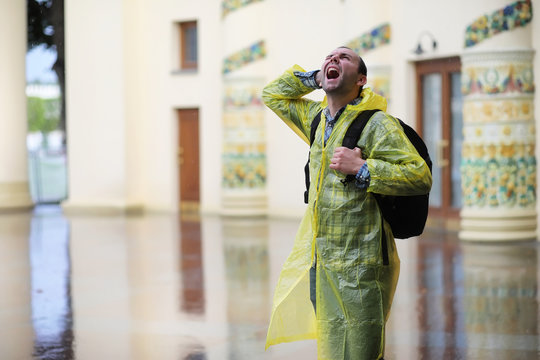 A man in a raincoat on a rainy day