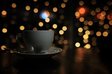 cup of coffee on the table on blured background with circle boke