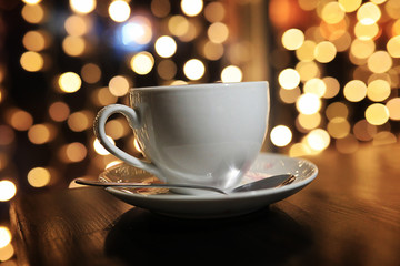 cup of coffee on the table on blured background with circle boke