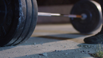 barbell for deadlift and foot athlete powerlifter competitions in powerlifting. Young athlete...