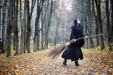 A woman in a witch suit in a forest