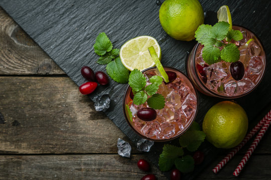 Cranberry mojito on rustic wood background