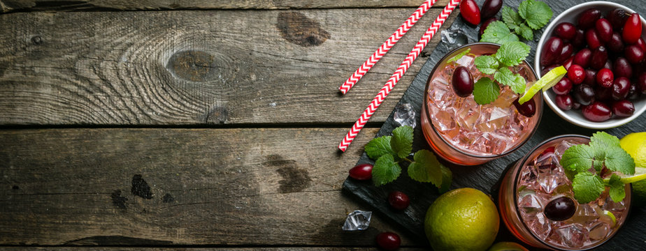 Cranberry mojito on rustic wood background