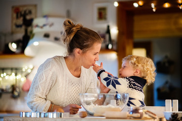 Young family making cookies at home.