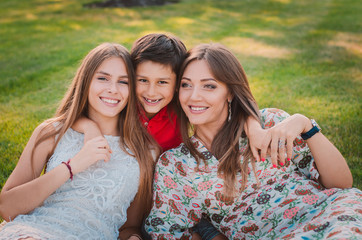 Obraz premium Happy family having fun in the summer at the park. Mom and children.