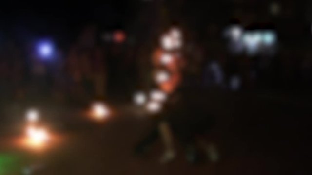 Amazing fireshow by young woman and man on a street.