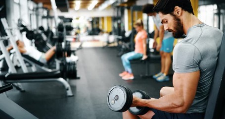 Young handsome man doing exercises in gym - Powered by Adobe