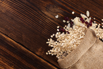 Oatmeal flakes, Cranberries and almonds in burlap bag