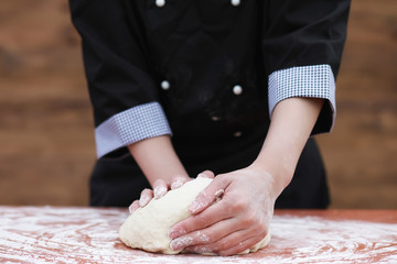 the cook makes flour for baking on the table