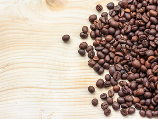 Roasted coffee beans on wooden background