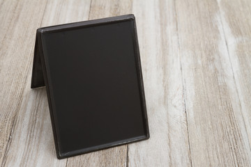 Retro freestanding chalkboard on weathered wood