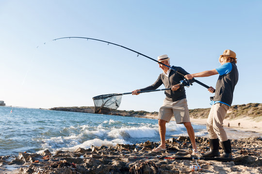 Senior Man Fishing With His Grandson