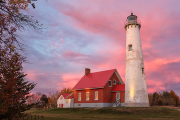 Tawas Point Lighthouse at Sunset in Tawas Michigan - obrazy, fototapety, plakaty
