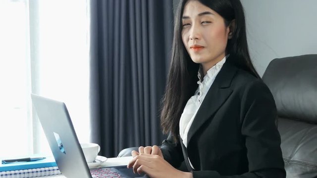 4k of young Asian Business woman working on laptop computer in office. close up business woman smile and happy