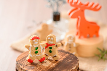 Christmas food. Gingerbread man and gingerbread star cookies in 

Christmas setting with elk. Xmas dessert