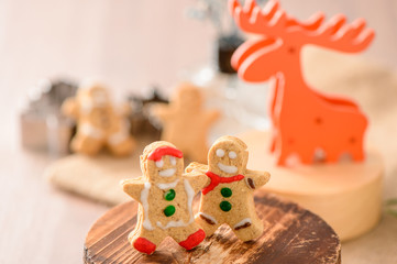 Christmas food. Gingerbread man and gingerbread star cookies in 

Christmas setting with elk. Xmas dessert