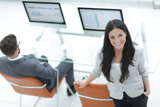 successful business woman standing near modern workplace