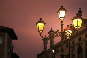 Fototapeta na wymiar Montagnana, Italy. street lamp shines on the city street.