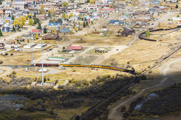 Aerial view of Silverton, Colorado in the fall with coal train and smoke
