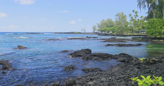 Tropical rocky beach bay Hilo Hawaii. Destination for swimming, scuba and snorkel, underwater fish and coral. Big Island, largest, most volcanic active. Economy is tourism based. Water and tropical.