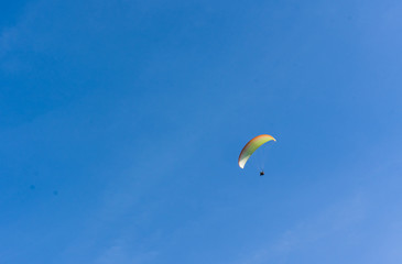 Blue sky with the extreme sport paragliding flying in sunny day