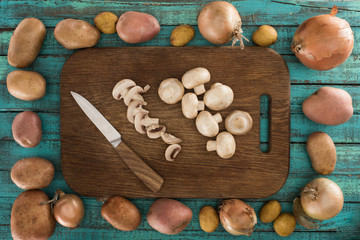 cut and whole mushrooms on wooden board