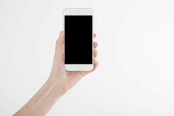 Fototapeta na wymiar Female hand holding smartphone with blank screen
