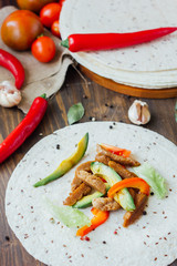 Mexican food - tortilla with traditional vegetarian fajitas on it.
