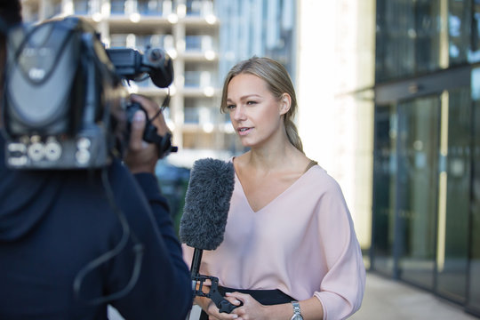 News presenter reporting to camera