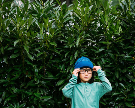 Young Mixed Race Boy in Hat and Glasses