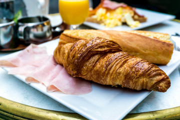 Breakfast with coffee and croissants on table