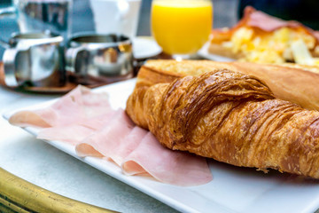 Breakfast with coffee and croissants on table