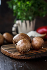 Food - mushrooms on wooden board on kitchen.