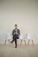 Businessman sitting in modern office while sitting in waiting room