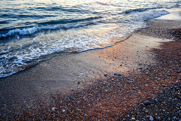 sea wave and pebble shore close-up, abstract natural background
