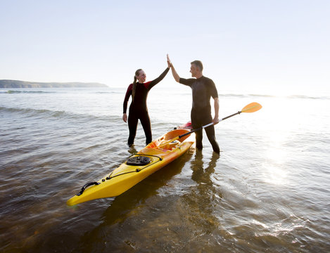 Surf couple at beach.